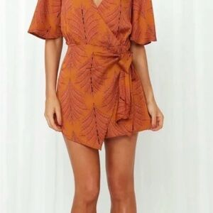 Saints & Secrets romper in Orange